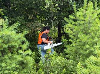 Harrisburg University student conducting ground geophysics survey in rural Pennsylvania